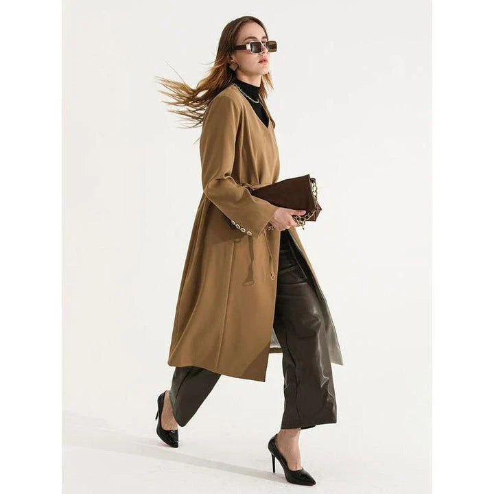 Women's full-length trench coat with lace-up waist, turn-down collar, and elegant full sleeves