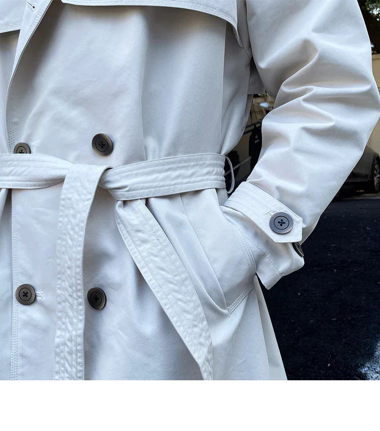 Commuter-friendly mid-length trench coat with double-breasted lapels, made from durable cotton-polyester blend fabric