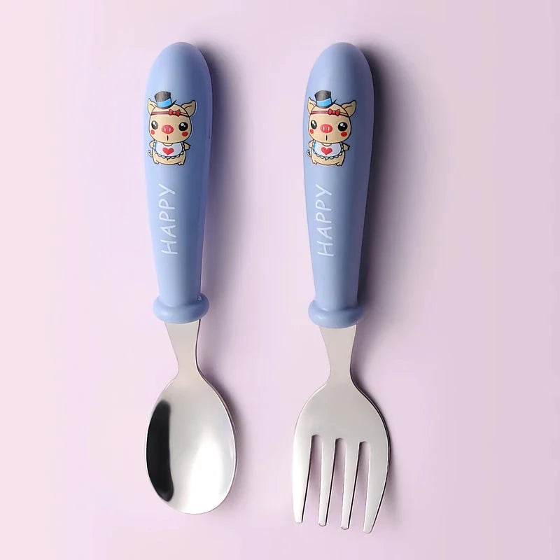 Charming cartoon-designed stainless steel toddler cutlery set with spoon and fork, perfect for mealtimes and self-feeding