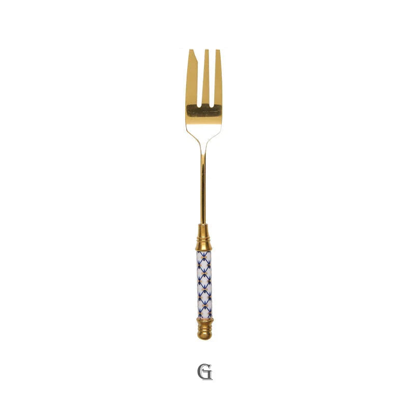 Elegant gold-plated dessert fork with intricate ceramic handle design
