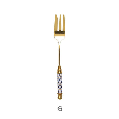 Elegant gold-plated dessert fork with intricate ceramic handle design