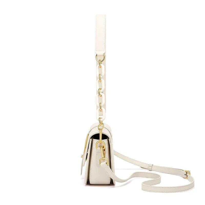 Elegant white leather crossbody bag for women with adjustable strap and multiple interior pockets for organized storage.