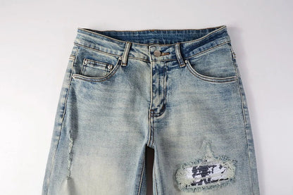 American High Street fashionable men's ripped black and white patch jeans in a light blue denim color