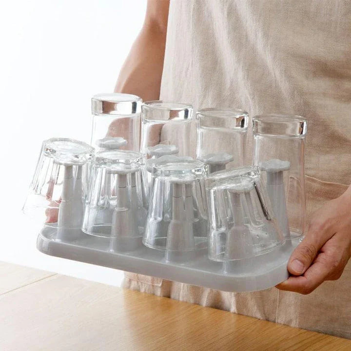 Flower-shaped mug holder rack in white, with 8 slots for organizing and displaying mugs on a kitchen countertop