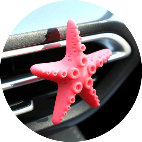 Cute mini starfish car vent air freshener in a rosy-pink color, emitting a refreshing cherry scent