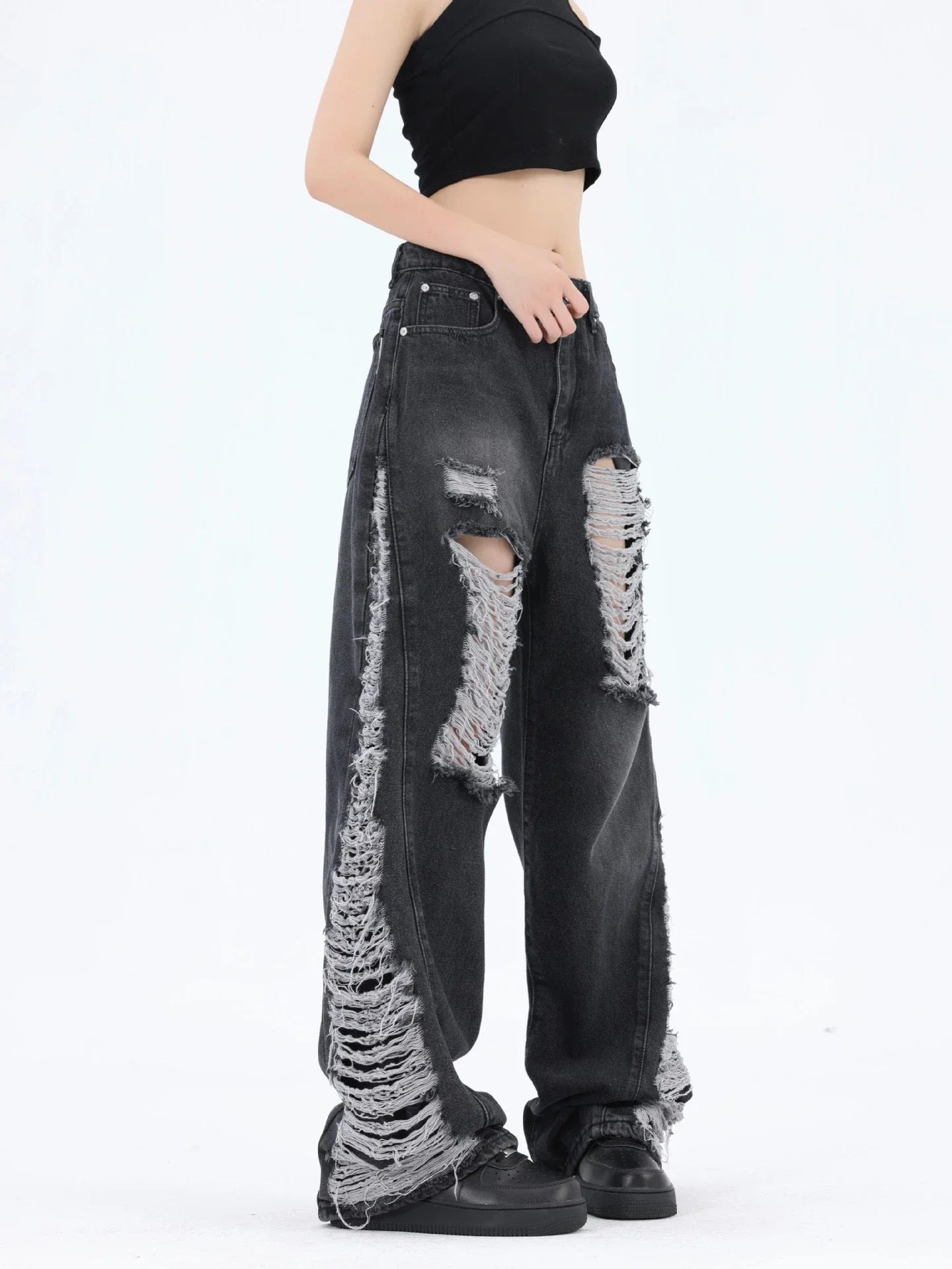 Premium loose fit distressed denim trousers for men and women, featuring a relaxed silhouette, high-quality cotton construction, and trendy distressed details.