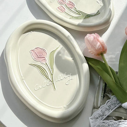 Elegant ceramic plate featuring a delicate floral relief design of Calla Lily and Tulip flowers, perfect for refined dining