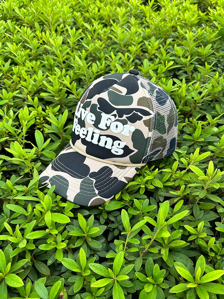Camo curved brim hat with embroidered 'Live For Feeling' slogan, adjustable size for all-day comfort and style