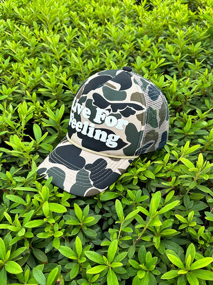 Camo curved brim hat with embroidered 'Live For Feeling' slogan, adjustable size for all-day comfort and style