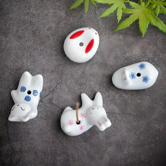 Charming ceramic incense holder featuring a cute rabbit and kitten design, perfect for adding a touch of whimsy and tranquility to any room.