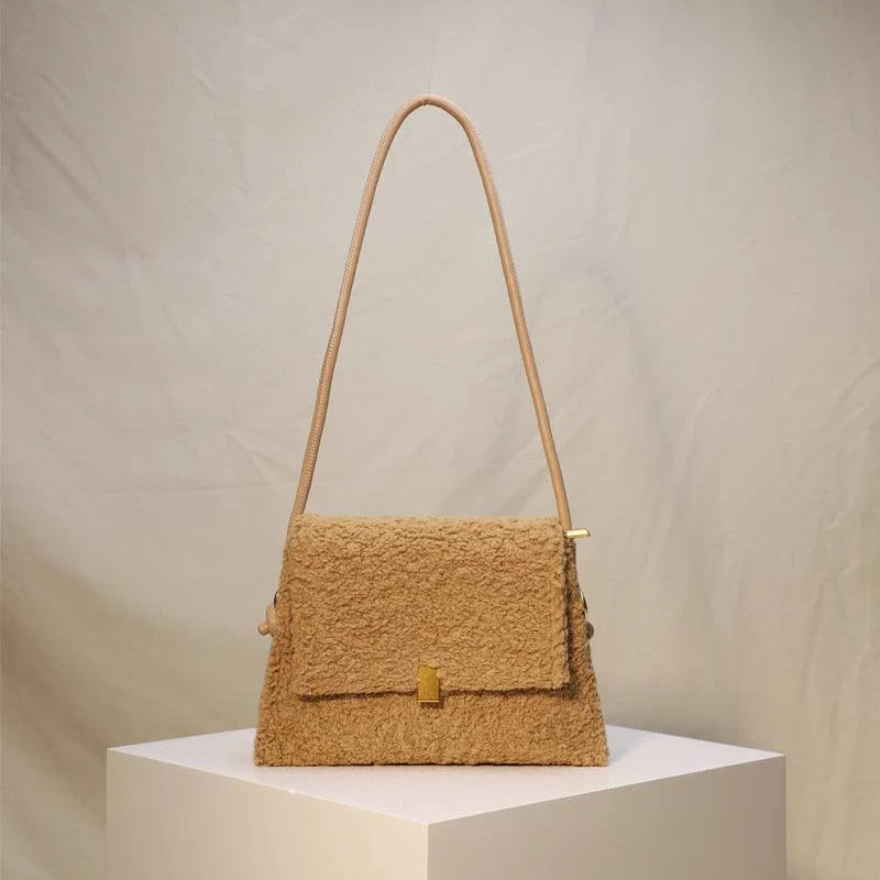 Stylish faux lamb wool crossbody shoulder bag in neutral colors with a cozy, plush exterior and organized interior pockets