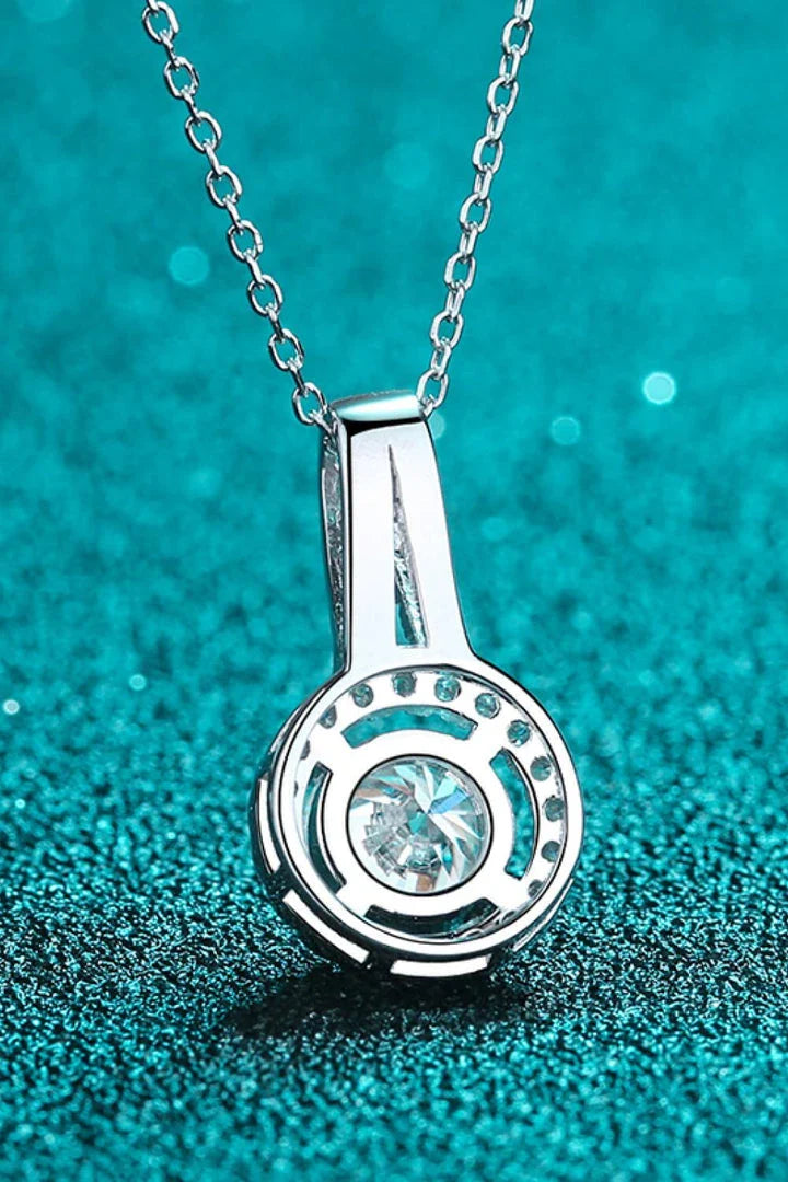 A sterling silver necklace with a round moissanite stone pendant, showcasing a sparkling and elegant design.