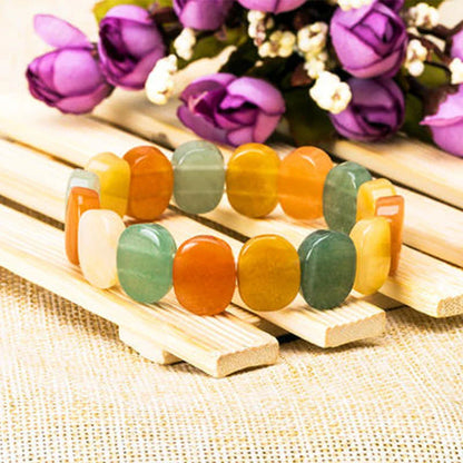 Closeup of a natural tiger eye crystal bracelet with a geometric design, showcasing its unique and calming beauty.