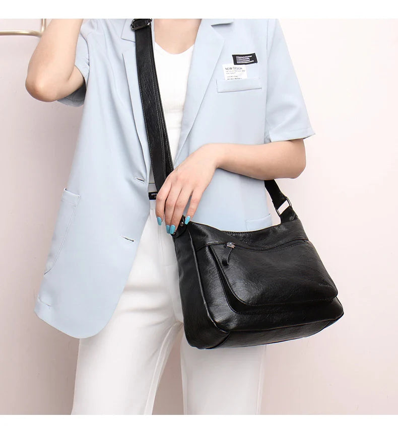 Stylish one-shoulder messenger bag in various colors with a soft, supple PU leather exterior and a spacious, organized main compartment