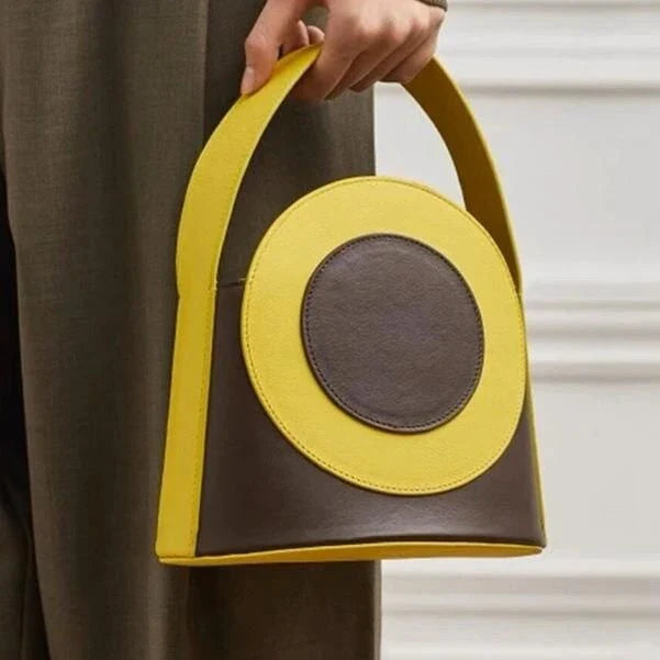 Chic color block vegan leather bucket bag with adjustable strap, perfect for everyday use and special occasions