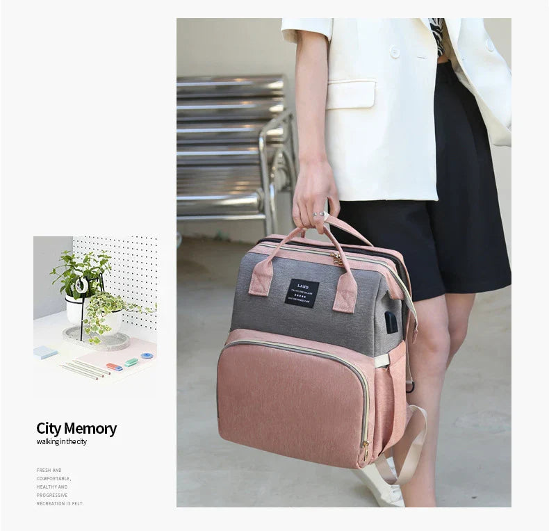 Multifunctional maternity diaper backpack with detachable crib, large capacity, and water-resistant design for travel