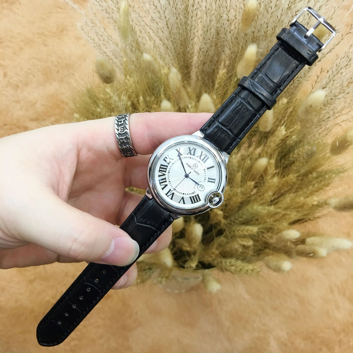 Stainless steel men's watch with large dial, calendar function, and adjustable band