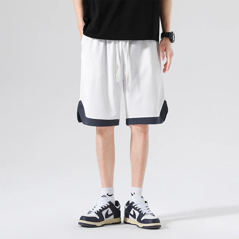 Men's loose and comfortable sports pirate shorts in white, gray, and black colors with elasticized waistband and relaxed fit