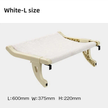 Cat relaxing in a cozy, hanging hammock bed placed in a sunny window