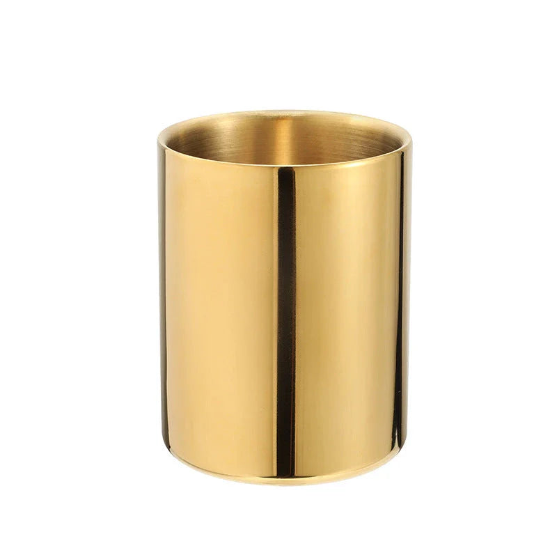 Elegant gold stainless steel desk organizer holding pens, pencils, and makeup brushes on a modern workspace