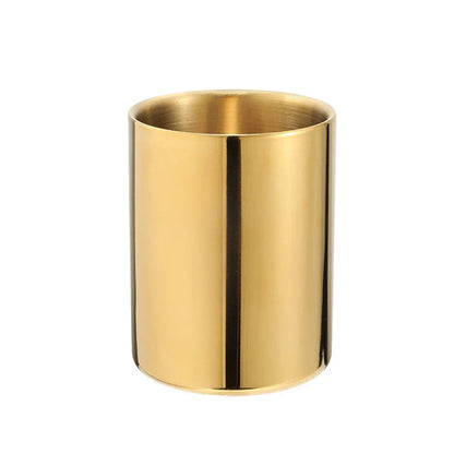 Elegant gold stainless steel desk organizer holding pens, pencils, and makeup brushes on a modern workspace