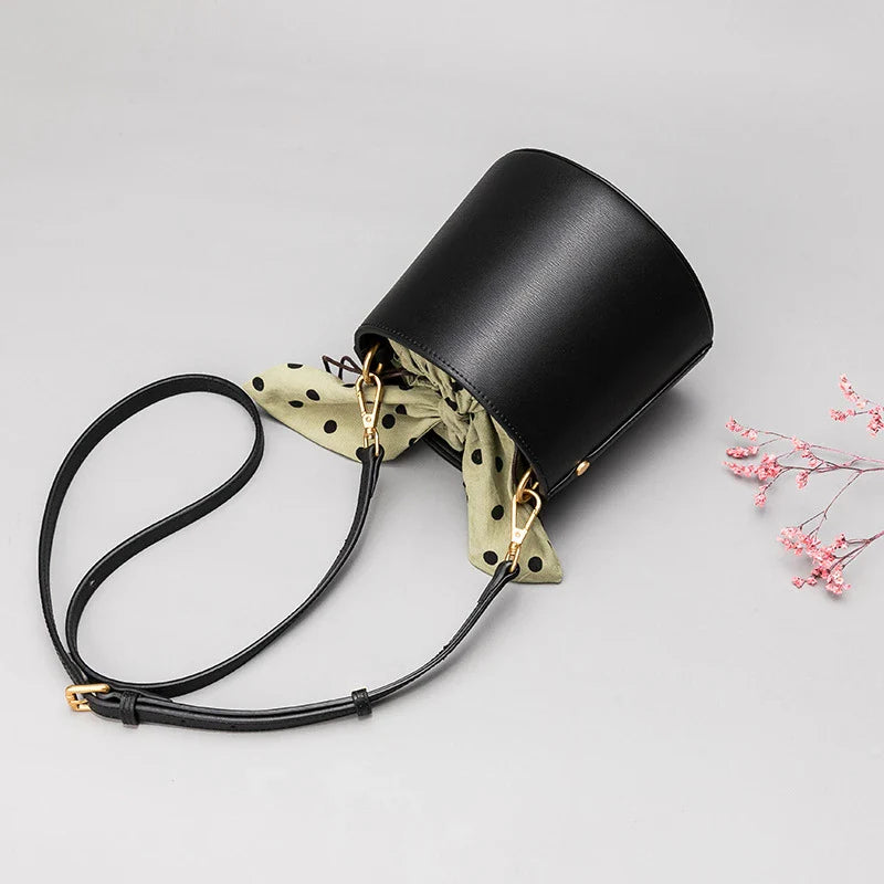 Premium leather bucket bag tote with bow-type closure, exquisite golden hardware, and versatile design