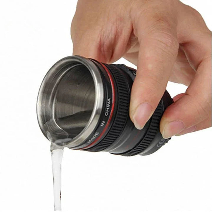 Stylish stainless steel and plastic shot glass with a miniature camera lens design, perfect for adding a unique touch to your home bar or cocktail setup.