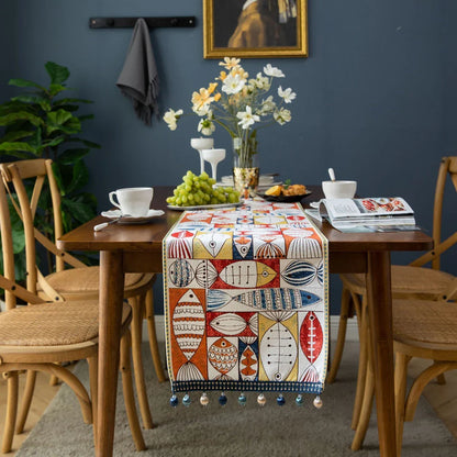 Festive jacquard table runner with vibrant fish design, available in multiple sizes to fit various dining tables