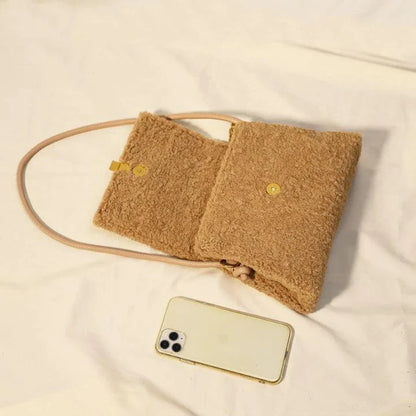 Stylish faux lamb wool crossbody shoulder bag in neutral colors with a cozy, plush exterior and organized interior pockets