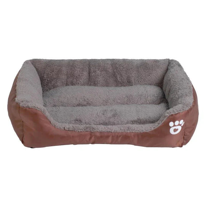 A plush, green pet bed with a paw-print pattern, designed to provide cozy and waterproof comfort for pets.