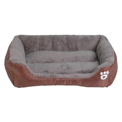 A plush, green pet bed with a paw-print pattern, designed to provide cozy and waterproof comfort for pets.
