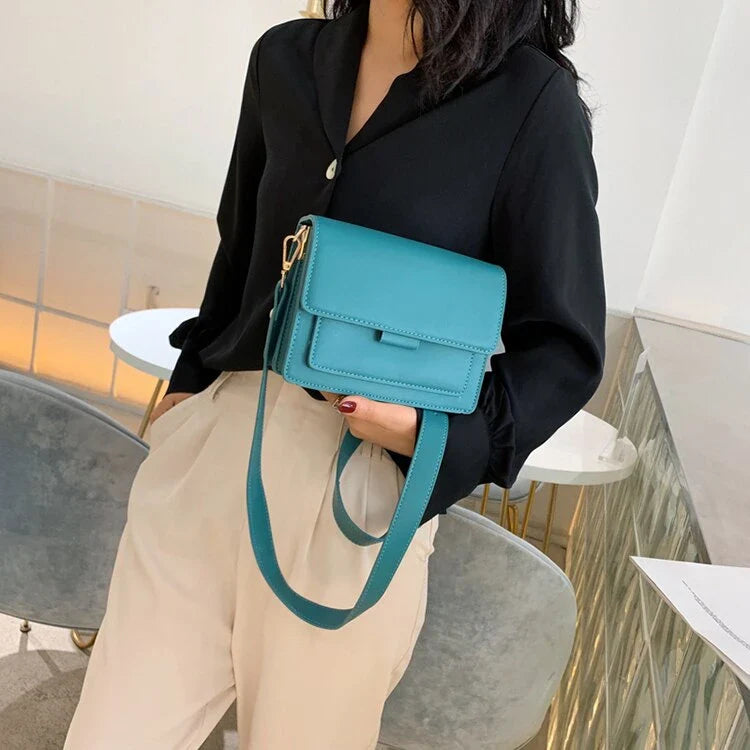 Stylish black crossbody shoulder bag with adjustable strap and multiple interior compartments for modern women
