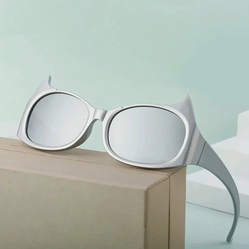 Stylish cat-eye sunglasses with oversized frames, semi-rimless design, and punk-inspired detailing for a timeless, glamorous look