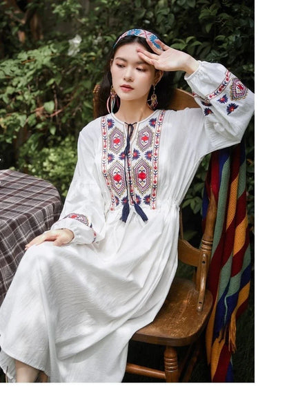 Elegant embroidered cotton-linen dress with tassels, featuring a waist-cinching A-line silhouette in vibrant colors