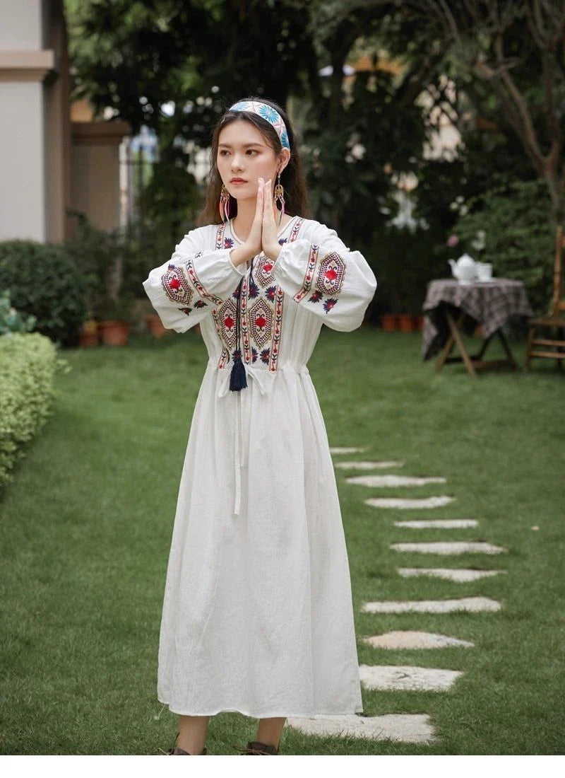 Elegant embroidered cotton-linen dress with tassels, featuring a waist-cinching A-line silhouette in vibrant colors