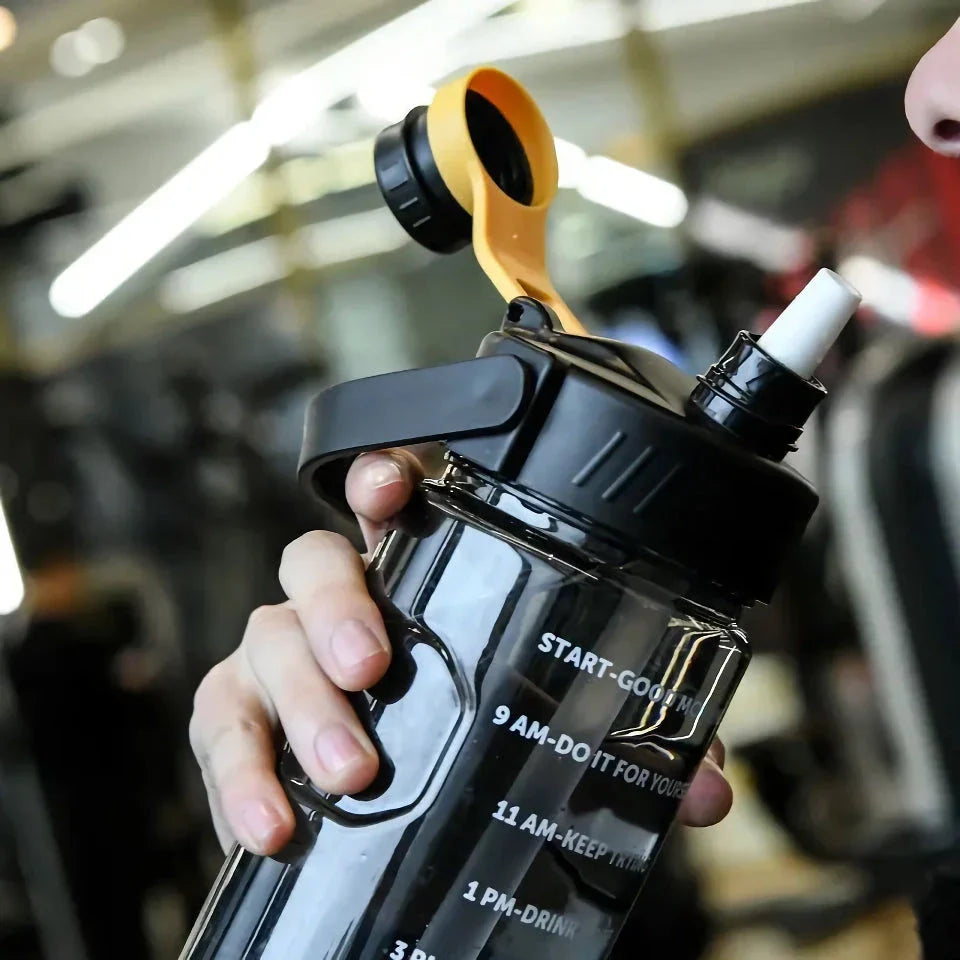 A large capacity sports water bottle with a straw lid and time stamps, designed for ultimate hydration and convenience.