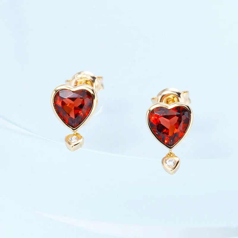 Elegant heart-shaped earrings with natural garnet and zircon stones in a pomegranate color, showcasing a timeless, versatile design.