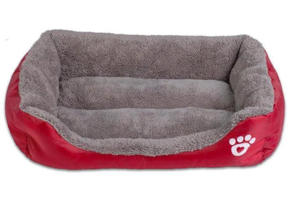 A plush, green pet bed with a paw-print pattern, designed to provide cozy and waterproof comfort for pets.