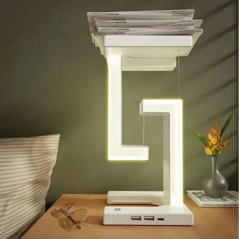 A modern, levitating desk lamp with wireless charging capabilities for smartphones