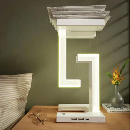 A modern, levitating desk lamp with wireless charging capabilities for smartphones