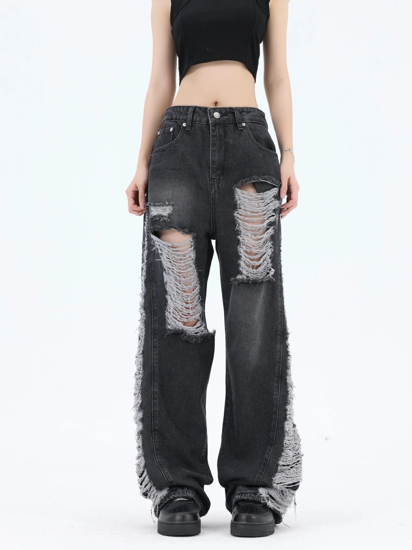 Premium loose fit distressed denim trousers for men and women, featuring a relaxed silhouette, high-quality cotton construction, and trendy distressed details.