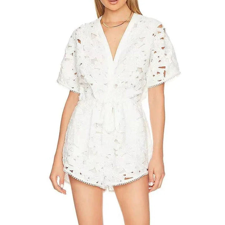 Chic embroidered hollow-out summer playsuit with a V-neck, high waistline, and short sleeves for a stylish and comfortable vacation or casual look.