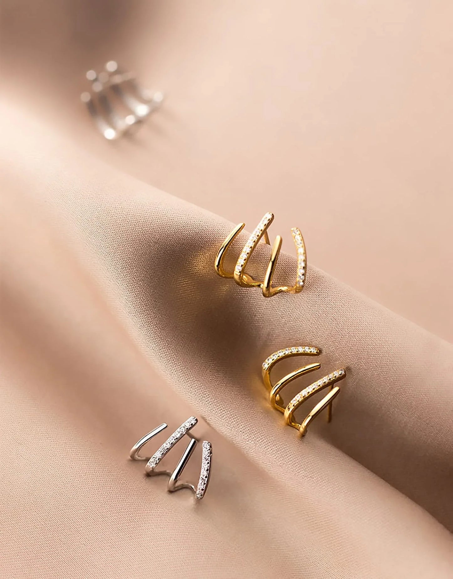 Elegant gold-toned zircon four-claw stud earrings with a classic cuff design, offering a sparkling and sophisticated look.