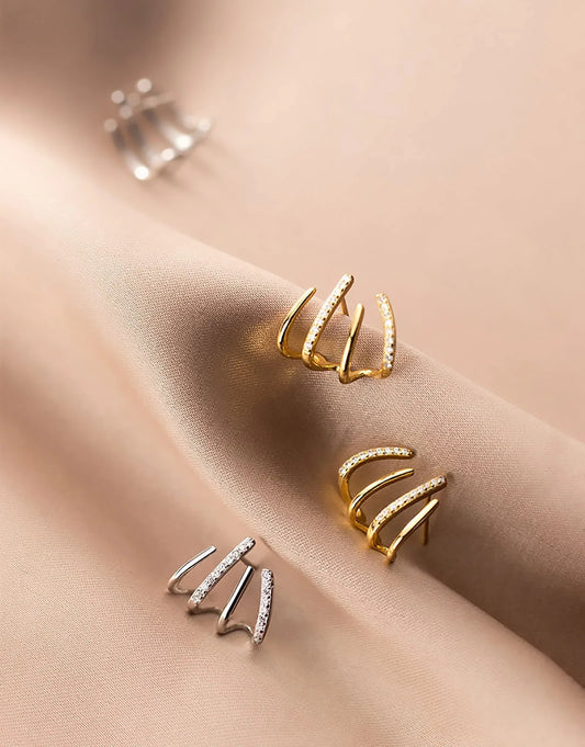 Elegant gold-toned zircon four-claw stud earrings with a classic cuff design, offering a sparkling and sophisticated look.