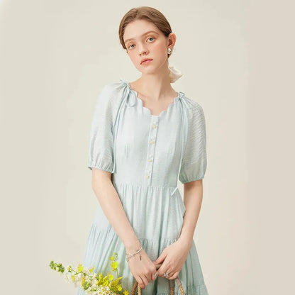 A chic, French-inspired summer dress with an empire waistline, V-neck, and A-line silhouette, perfect for seaside elegance.