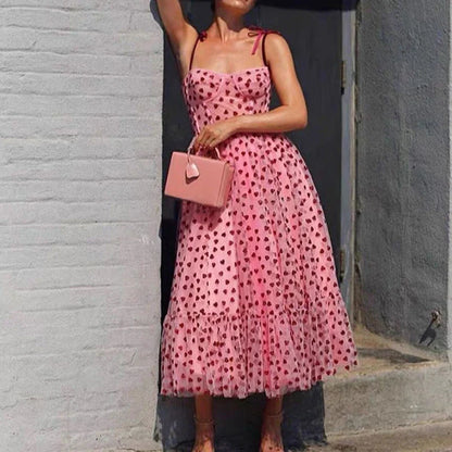 A stylish polka dot dress with a bandeau waist and flared skirt, perfect for elegant occasions or everyday wear.