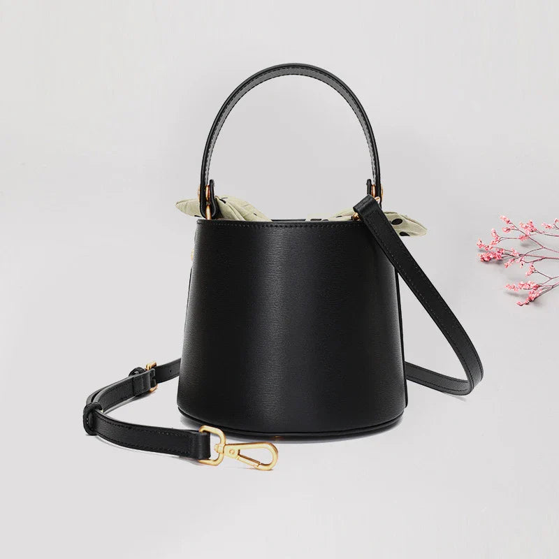 Premium leather bucket bag tote with bow-type closure, exquisite golden hardware, and versatile design