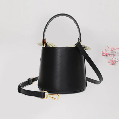 Premium leather bucket bag tote with bow-type closure, exquisite golden hardware, and versatile design