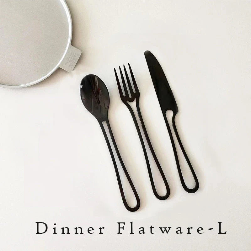 Sleek and modern 304 stainless steel cutlery set with a black finish, including knife, fork, and spoon for dinner and dessert.