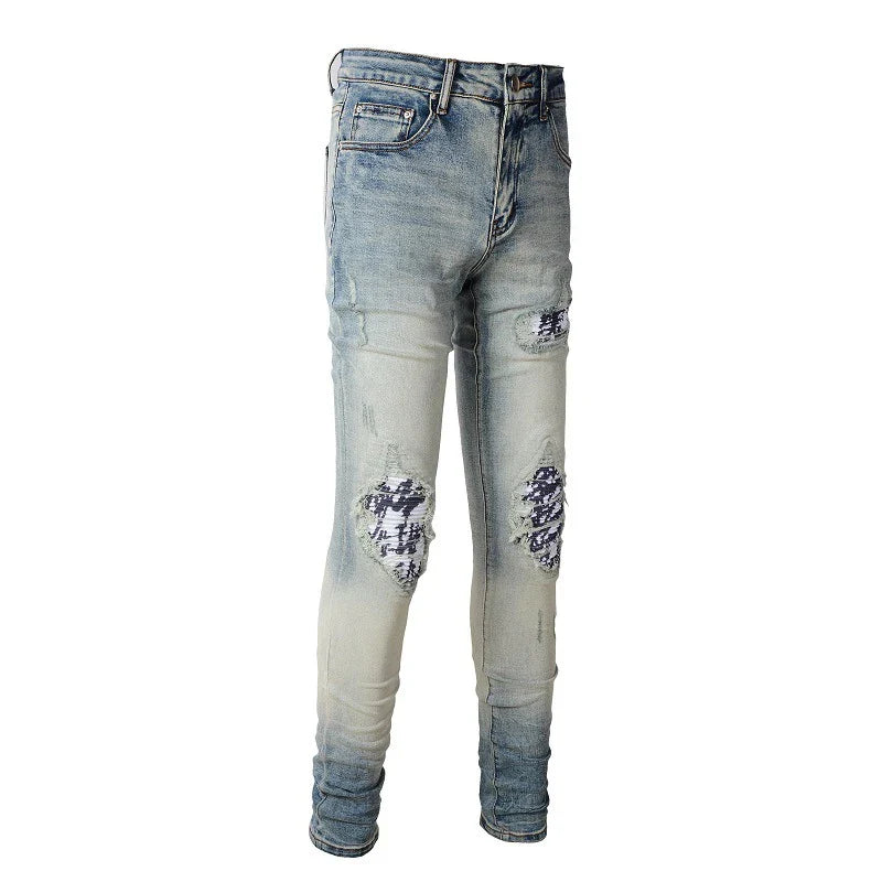 American High Street fashionable men's ripped black and white patch jeans in a light blue denim color
